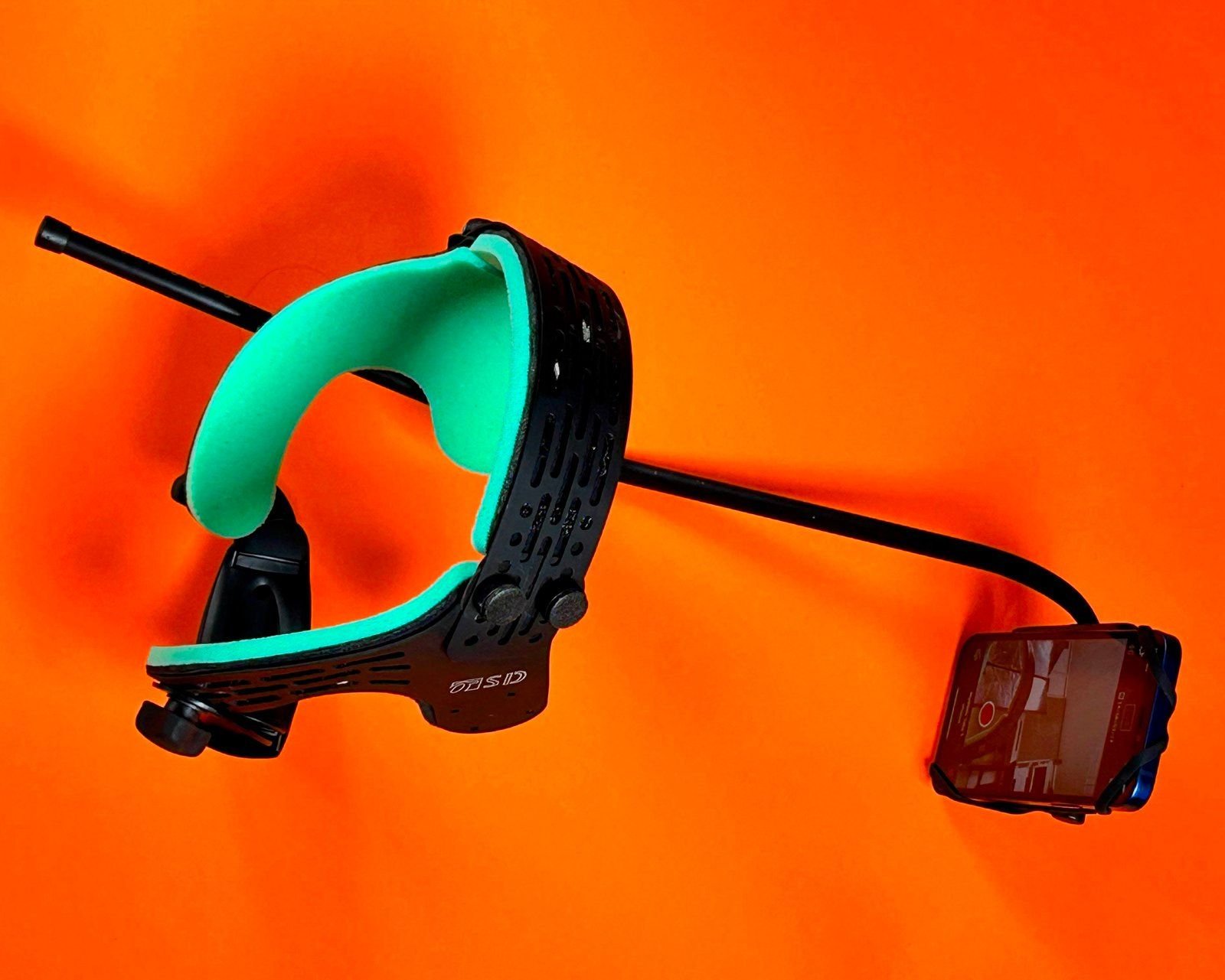 Head-mounted facial capture rig on an orange background